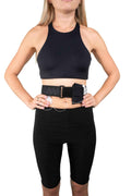 A woman wearing Pumpcases Adjustable Waistband Black Insulin Pump Case and black gym clothing on a white background.