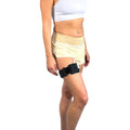 A woman wearing a Pumpcases black Tandem Diabetes Mobi compatible thighband case.