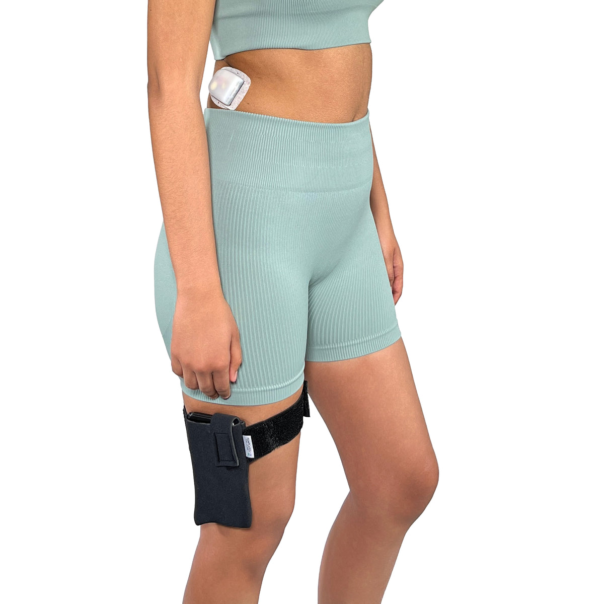 A woman wearing a Pumpcases Omnipod 5 PDM black thighband case on a white background.