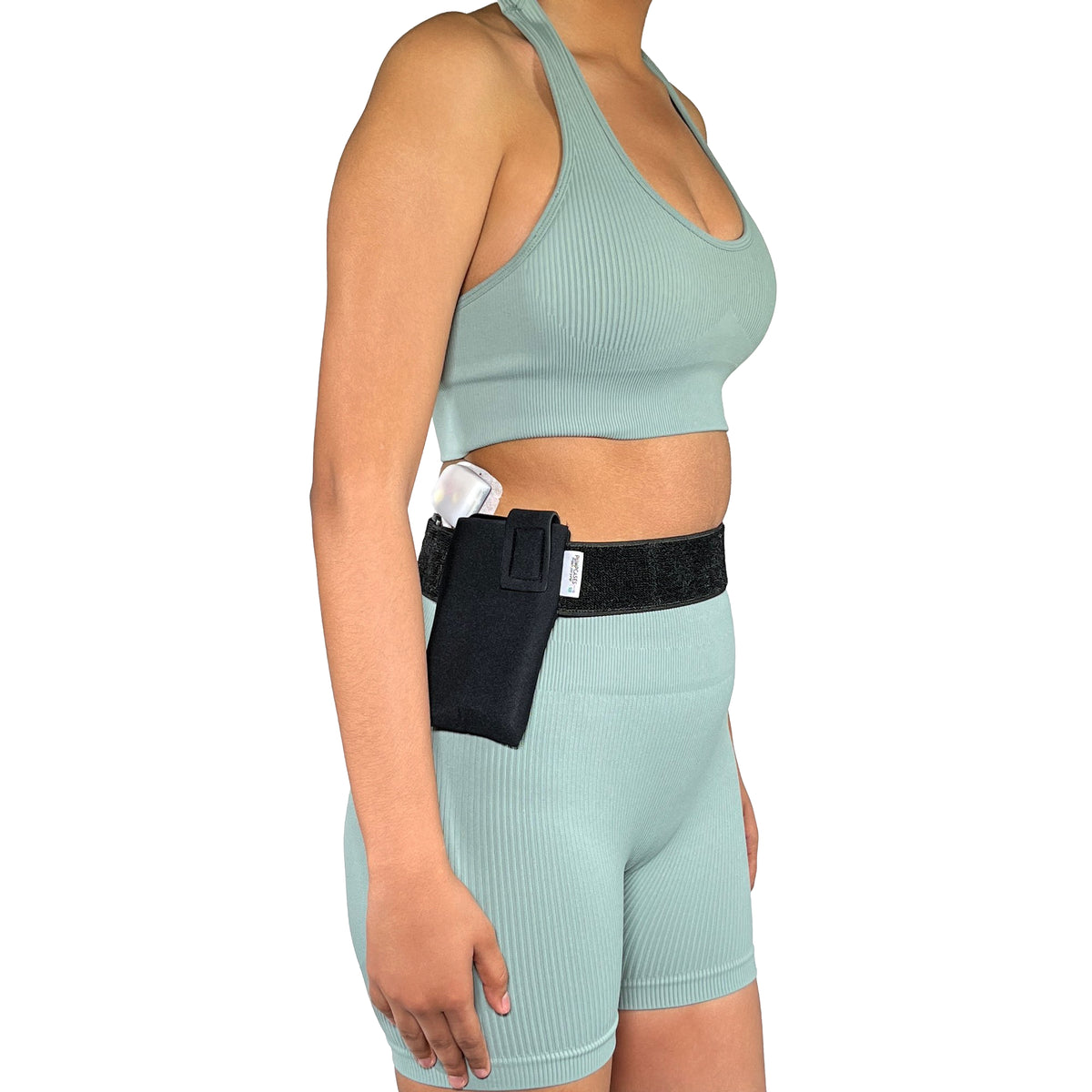A woman wearing a Pumpcases Omnipod 5 PDM black waist belt case on a white background.