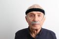 Man wearing oxygen tubing with a black headband against a white background